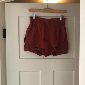 Burnt orange Lululemon running shorts